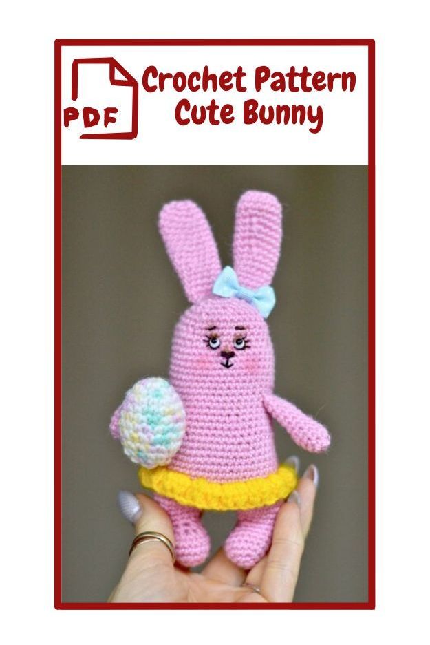 The image shows a crochet pattern for a cute bunny. The bunny is crocheted in pink yarn and has long ears. It is wearing a yellow skirt and has a ligh